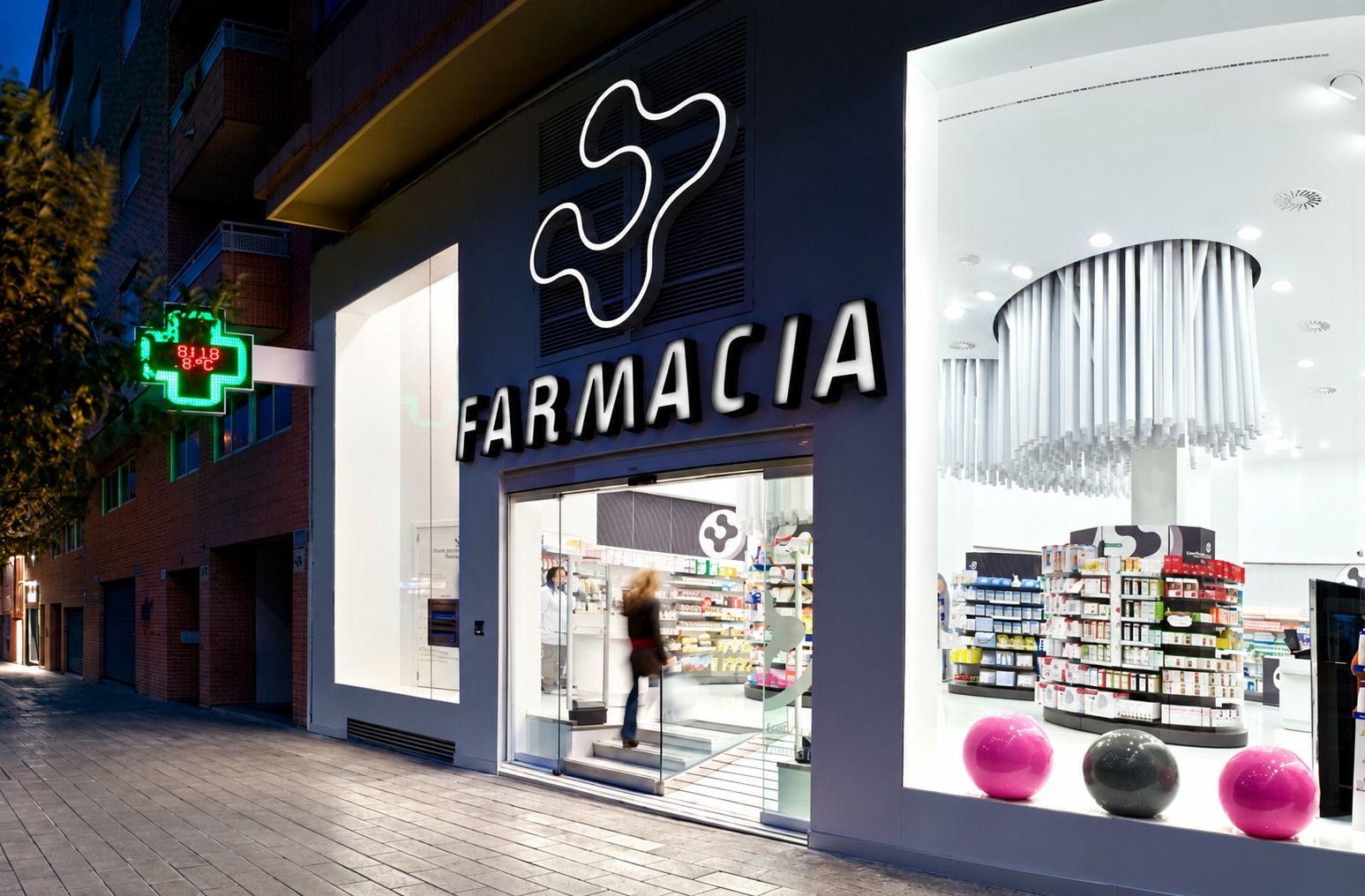 Fachada nocturna de Farmacia Conde Lumiares